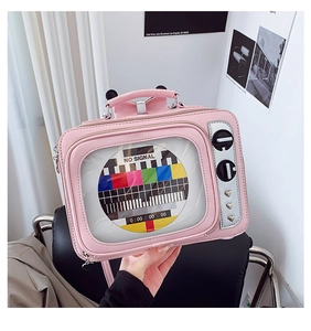 Macro view of retro pink television bag featuring decorative hearts and no signal screen