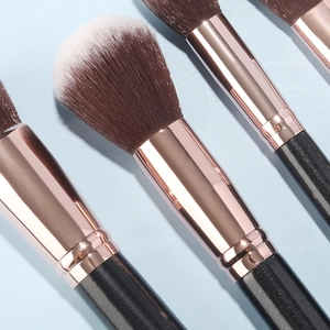 Detail of premium makeup brushes with rose gold ferrules and black glitter handles