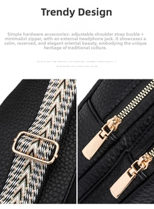 Detail of black lychee leather chest bag with golden double zippers and adjustable strap