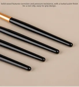 Detail of lacquer finish solid wood makeup brush handle with gold metal ferrule