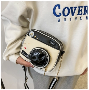 Detail of creative camera-shaped crossbody bag with unique straps and playful prints