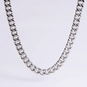 Detailed view of silver polished stainless steel Cuban link chain with glossy finish