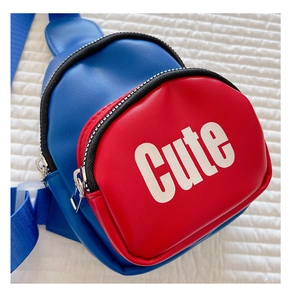 Close-up of red and blue kid chest bag with white CUTE text on quilted background