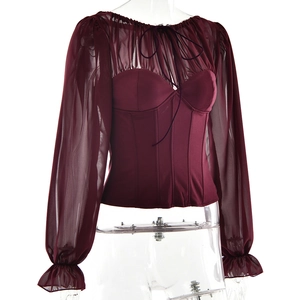 Detail of wine red corset top with sheer mesh puff sleeves and lace-up neckline