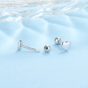 Detail of silver S925 heart earrings with secure screw-back ball closures and hallmark