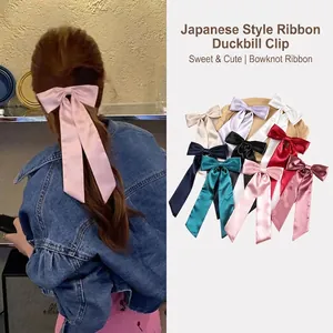 Elegant satin bow hair clip with long ribbons in multiple colors for women