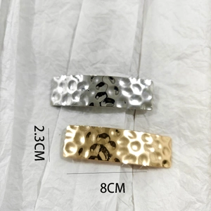 Detailed view of gold and silver brushed alloy hair clips measuring 8cm by 2.3cm