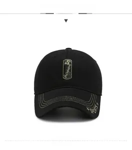 Detail of black baseball cap featuring gold Sports embroidery and stitched brim accents