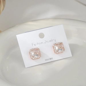 Macro shot of S925 silver rose gold square halo earrings with sparkling zircon stones