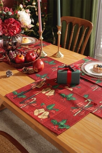 Detailed festive scene with red Christmas table runner and placemats on a wooden table
