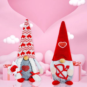 Close-up of Valentines Day gnomes with red hearts and roses in a romantic gift setting