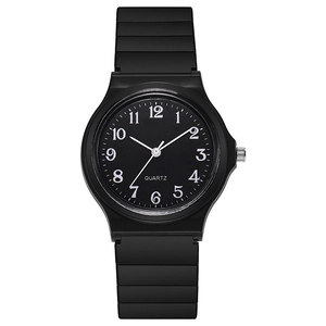 Close-up of minimalist black quartz watch with white numerals and rubber strap detail