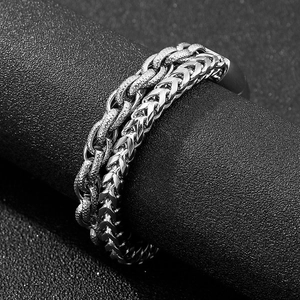 Macro shot of silver titanium steel wheat chain texture wrapped around a black prop