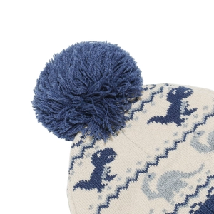 Detail of soft knitted hat with dinosaur patterns and a fluffy blue pom-pom on top