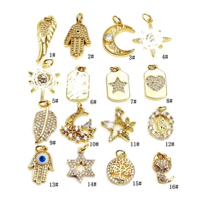 Set of 16 gold micro-pave zircon pendants featuring hamsa, moon, and star designs