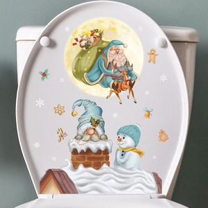 Festive Santa and reindeer decals on a white toilet lid for Christmas bathroom decor