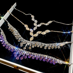 Close-up of diamond waterdrop tassel necklaces in silver, gold, and purple finishes