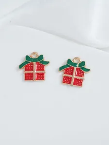 Detailed view of alloy Christmas gift box charm with red enamel and green bow for DIY jewelry