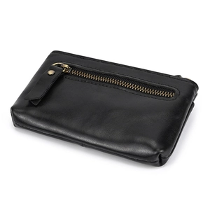 Detailed view of the grain leather coin purse with brass zipper and leather puller