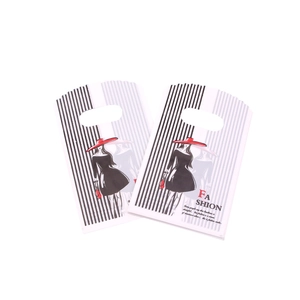 Detail of white 9x15cm plastic gift bag with black stripes and Fashion typography