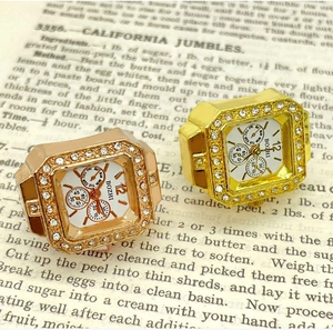 Detail view of gold and rose gold octagon ring watches with shimmering crystal bezels