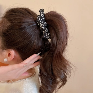 Close-up of leopard print hair scrunchie on high ponytail for elegant Korean styling
