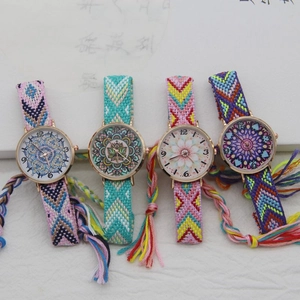 Close-up of bohemian woven fabric watch straps with fringe and mandala dial patterns