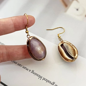 Elegant Bohemian shell drop earrings with natural purple shells and gold hooks