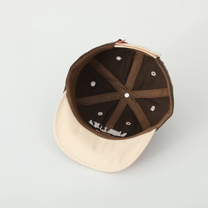 Detailed inner view of kids' cotton cap showing ALINA embroidery and reinforced stitching
