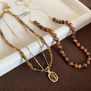 Irregular tiger eye beaded necklace and rectangular pendant in vintage gold finish