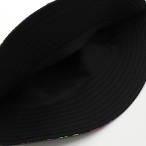 Detail view of the black bucket hat inner lining and colorful graffiti print brim stitching