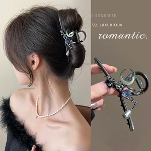 Deep gunmetal moon hair claw clip with ice-crack stones and pearl tassel pendant
