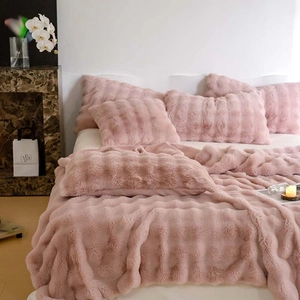 Detail showing the ultra-soft pink faux rabbit fur texture of the plush bedding set