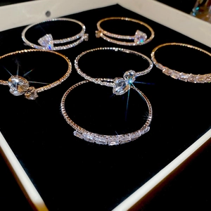 Detailed view of luxury zircon square bracelets in gold and silver on black velvet