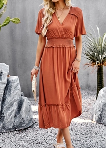 Detail of V-neck short sleeve dress in orange-brown with elastic waist and ruffle hem