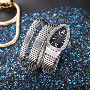 Close-up of Cussi snake-shaped wrap watch with crystal bezel and blue hands on starry background