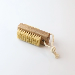 Detail view of beechwood nail brush with natural bristles and hanging jute rope loop