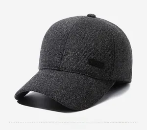 Detailed close-up of dark grey winter baseball cap featuring knit texture and sport patch