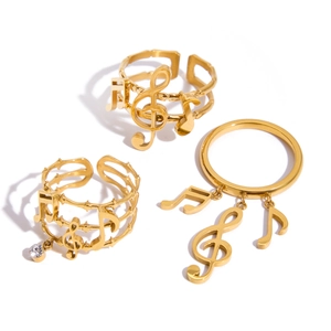 Three-piece gold music note ring set with treble clef design and white rhinestones