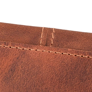Macro shot showing premium dark brown crazy horse leather texture and precise stitching