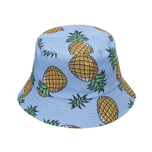 Close-up of light blue bucket hat with yellow pineapple print and fine stitching