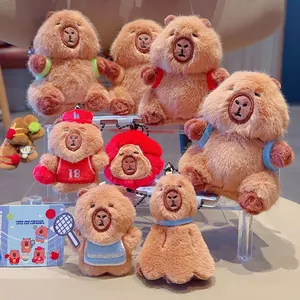 Capybara plush keychain set featuring basketball and tennis sports themes on display stand