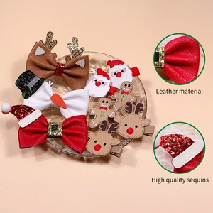 Christmas hair clips set featuring leather reindeer, Santa, and sequined gingerbread man
