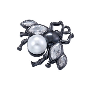 Macro detail of bee pendant featuring white pearl abdomen and sparkling zircon wings