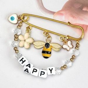 Golden Evil Eye brooch pin with heart charm, bee pendant and HAPPY letter beads