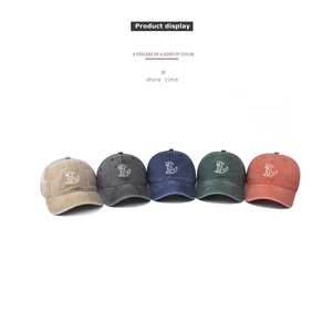 Detailed display of washed cotton baseball caps with dog embroidery in five vintage colors