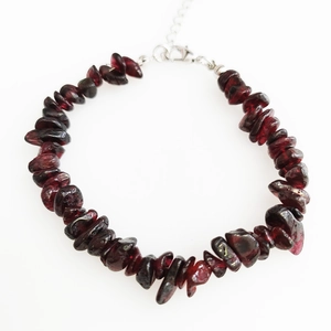 Detailed view of natural garnet chip bracelet with silver lobster clasp and extension chain