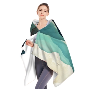 Detail view of microfiber beach towel with blue gradient wave pattern and hemmed edges