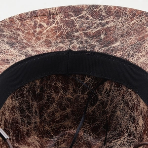 Macro detail of faux suede cowboy hat showing crackle texture and inner sweatband