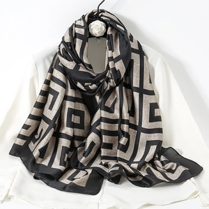 Elegant silk scarf featuring classic black and beige Greek key geometric patterns